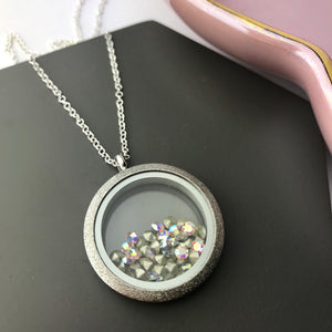 Stainless steel locket with Swarovski elements crystals on sterling silver chain.