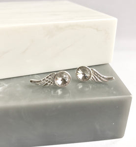 Sterling silver wing stud earrings with crystal detail.
